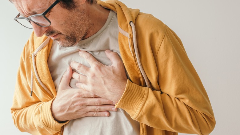 man holding chest