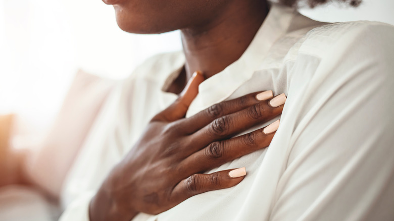 woman holding her heart