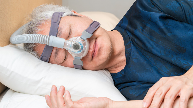 middle-aged man wearing CPAP machine
