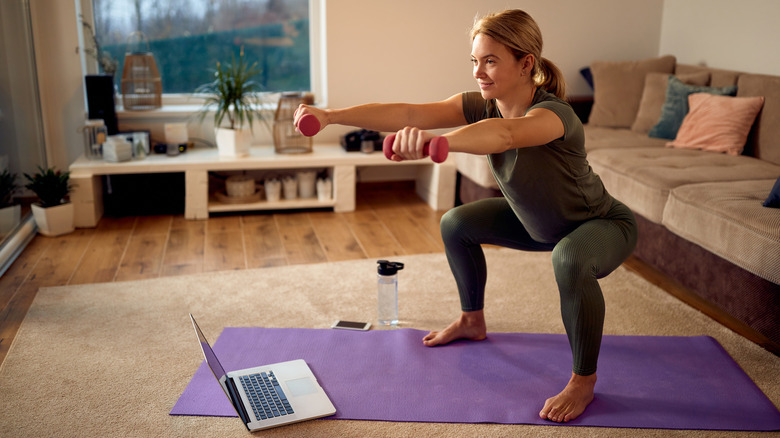 A woman does squats at home