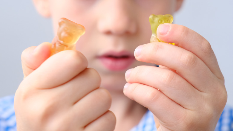 little boy holding gummies