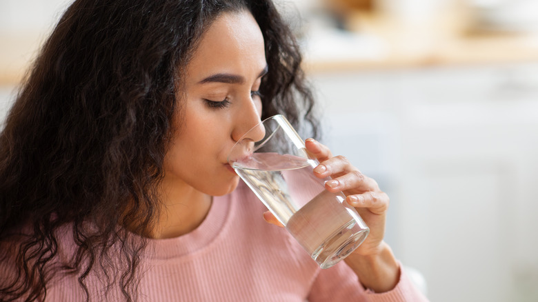 woman drinking a glass of water