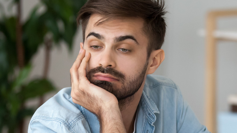 pensive man looking bored