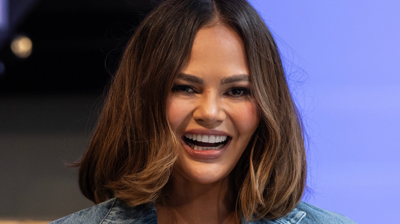 Chrissy Teigen smiling at an event