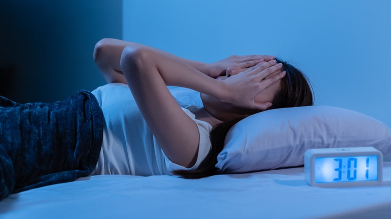 Woman in bed lying awake with insomnia