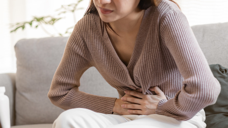 girl holding abdomen