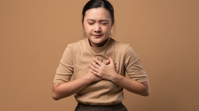 Coughing person with red neck and chest