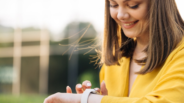 smiling woman wearing smart watch