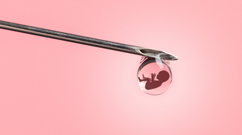 illustration of baby inside tiny bubble at the end of a needle