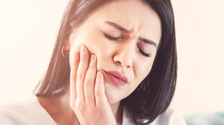 Woman with tooth pain due to a dry socket