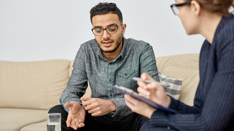 Young man talking to therapist