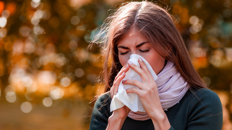 Woman blowing her nose