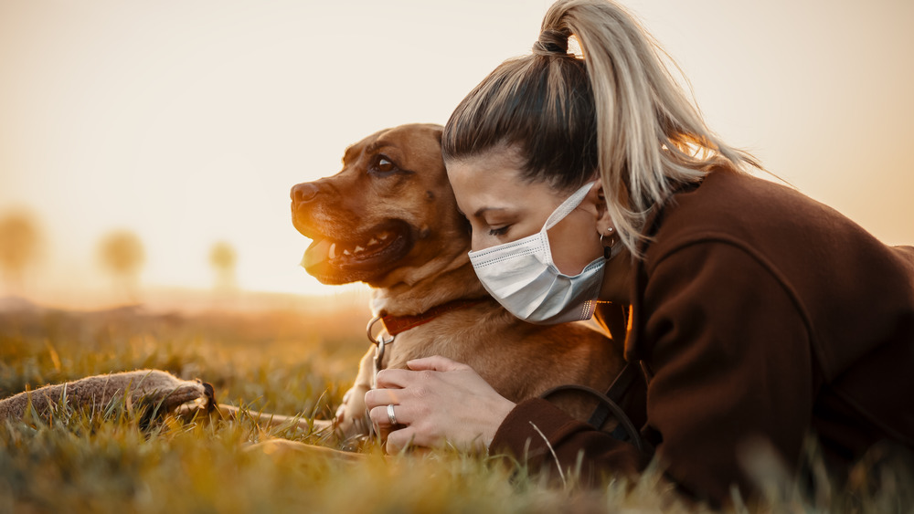 Dog and woman with mask