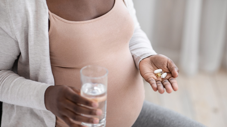 Pregnant woman taking vitamins