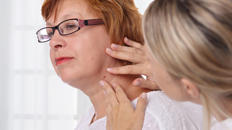 A dermatologist examining a patient