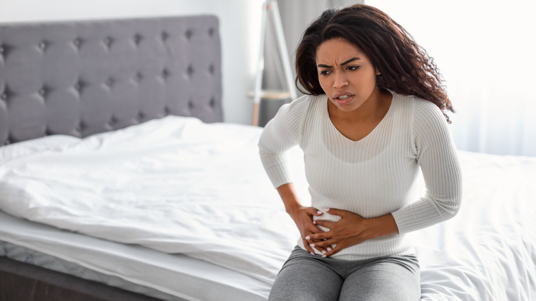 woman with ibd sitting on bed