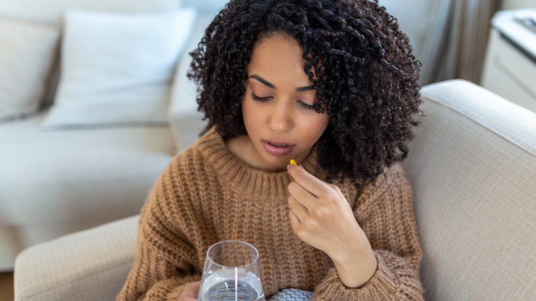 Woman about to take a pill 