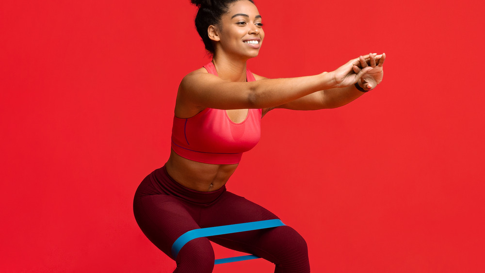 Woman doing banded squats