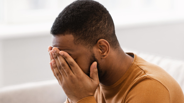 Man with head in hands