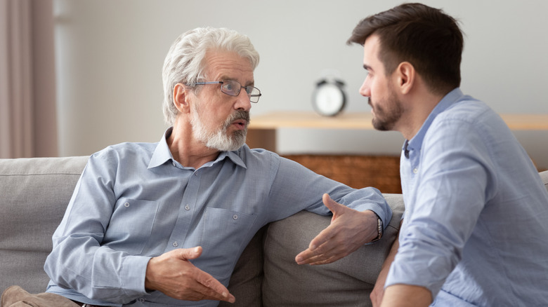 older and younger man conversing