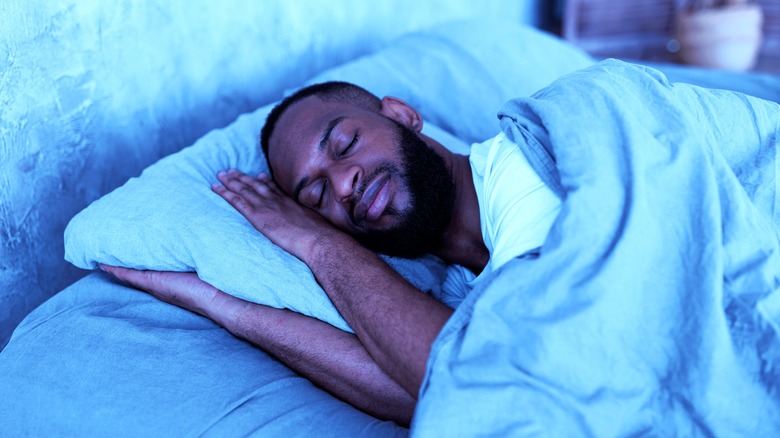 man sleeping in bed
