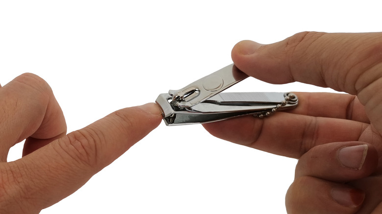 person cutting fingernails