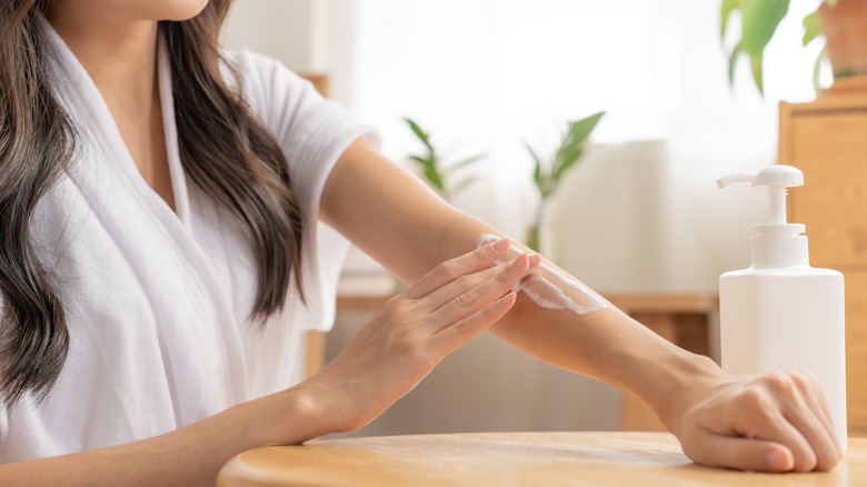 woman moisturising skin