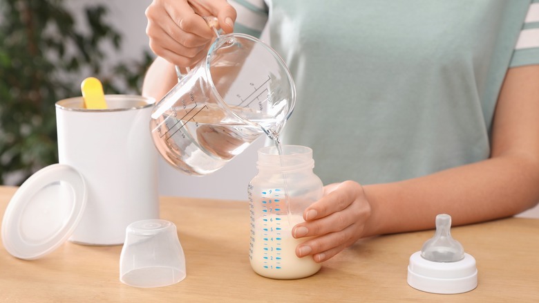 woman preparing infant formula
