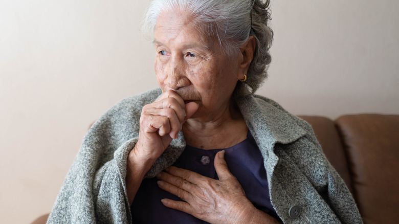 senior asian woman coughing