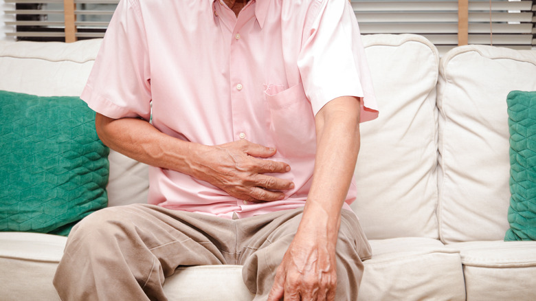 man holding belly