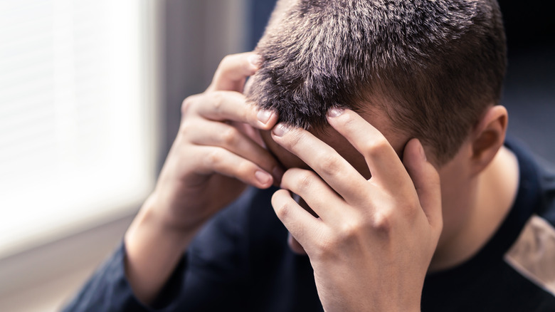 Anxious man holding head