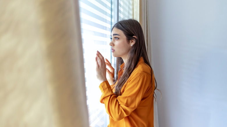 Woman looking out window