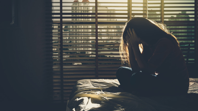 woman in bed with headache