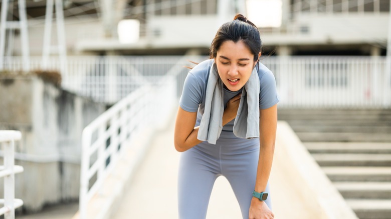 A woman is tired while working out