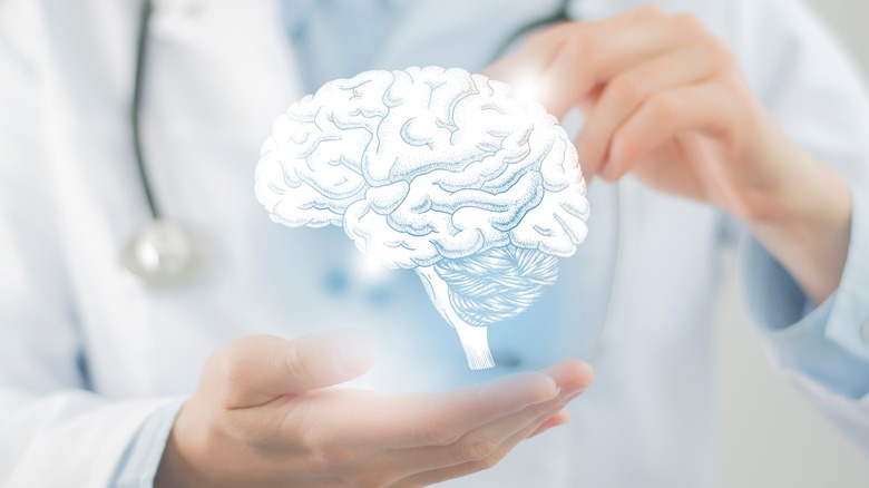 doctor holding a hologram image of the brain