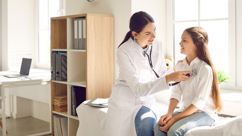 doctor examining child