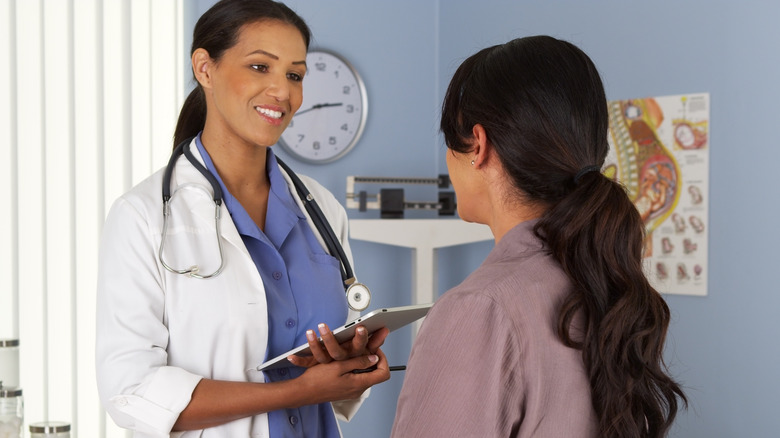 Woman with doctor in exam room