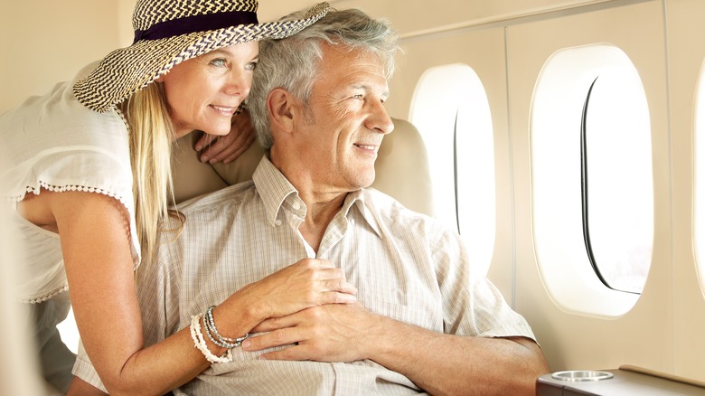 Couple looking out airplane window