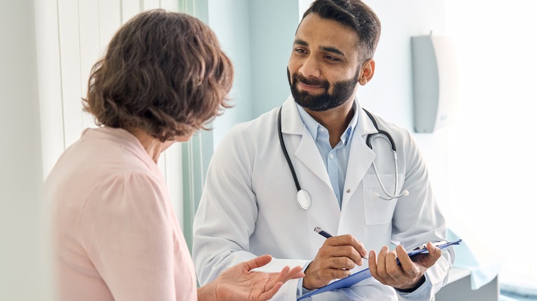 A woman speaking with a doctor