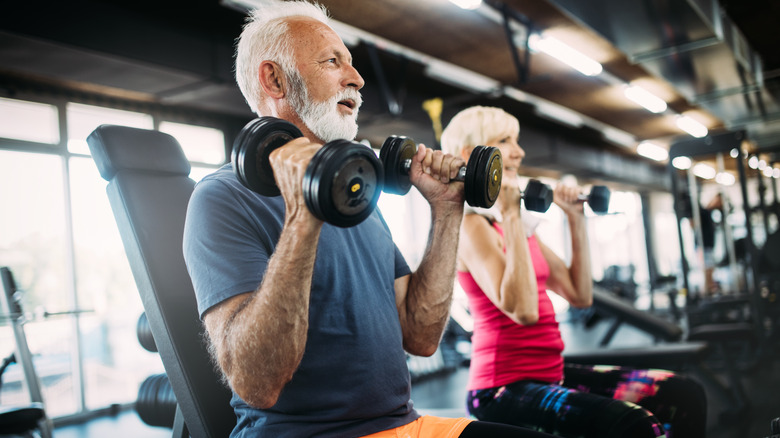 an older couple working out at the gym