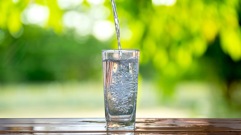 pouring water in a glass