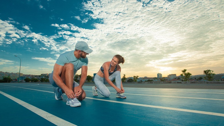 Two people prepare for a run