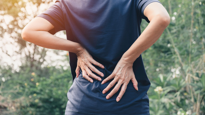 Woman holding her lower back