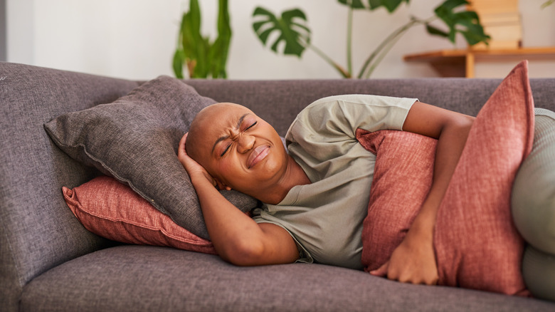 Woman clutching her stomach in pain