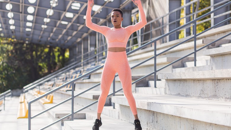 Woman jumping up from a burpee