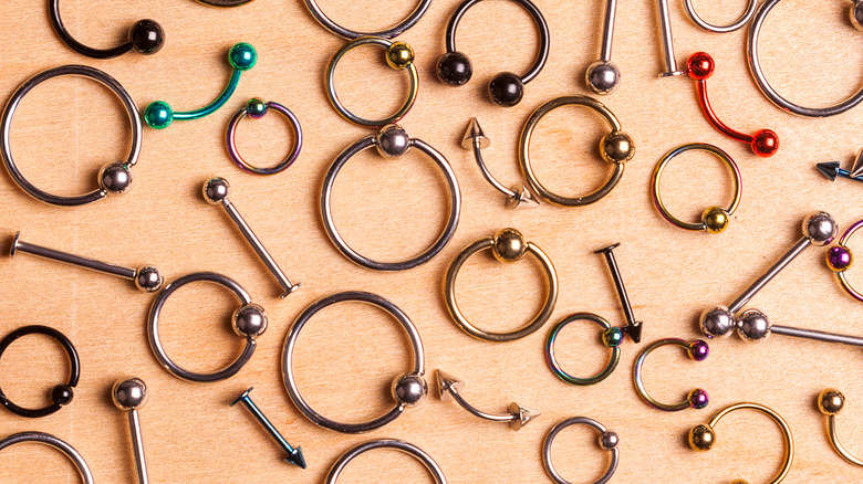 Body jewelry on wooden table