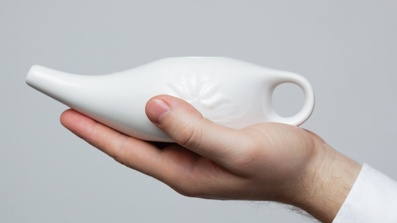 close-up of a green plastic neti pot