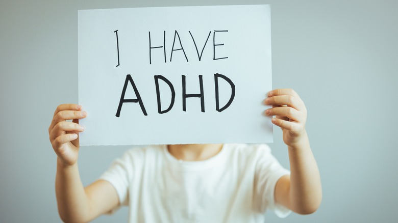 Woman holding ADHD sign 