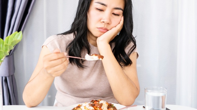 woman staring at a fork