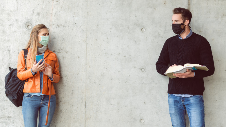 Man and woman outside looking at each other